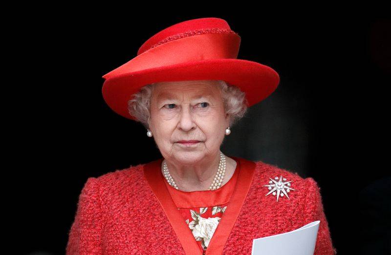 Image may contain: Elizabeth II, Person, Adult, Clothing, Hat, Face, Head, Accessories, Jewelry, and Necklace