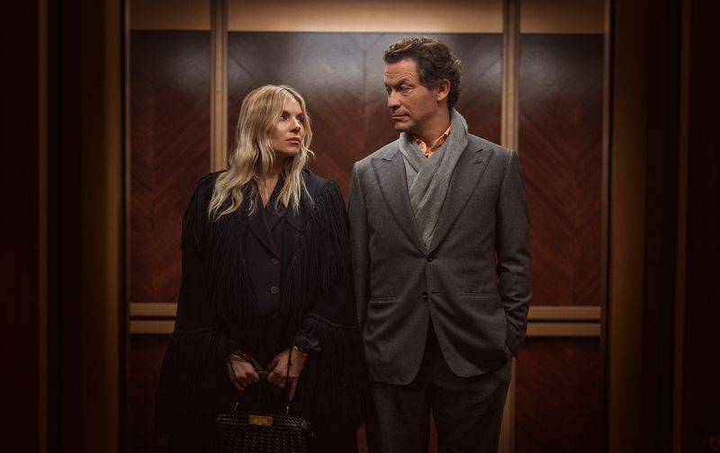 Image may contain: Dominic West, Sienna Miller, Clothing, Coat, Jacket, Adult, Person, Accessories, Bag, Handbag, and Blazer