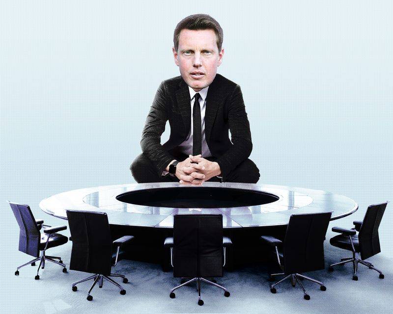 Image may contain: David Ellison, Furniture, Table, Chair, Clothing, Formal Wear, Suit, Accessories, Tie, Person, and Sitting