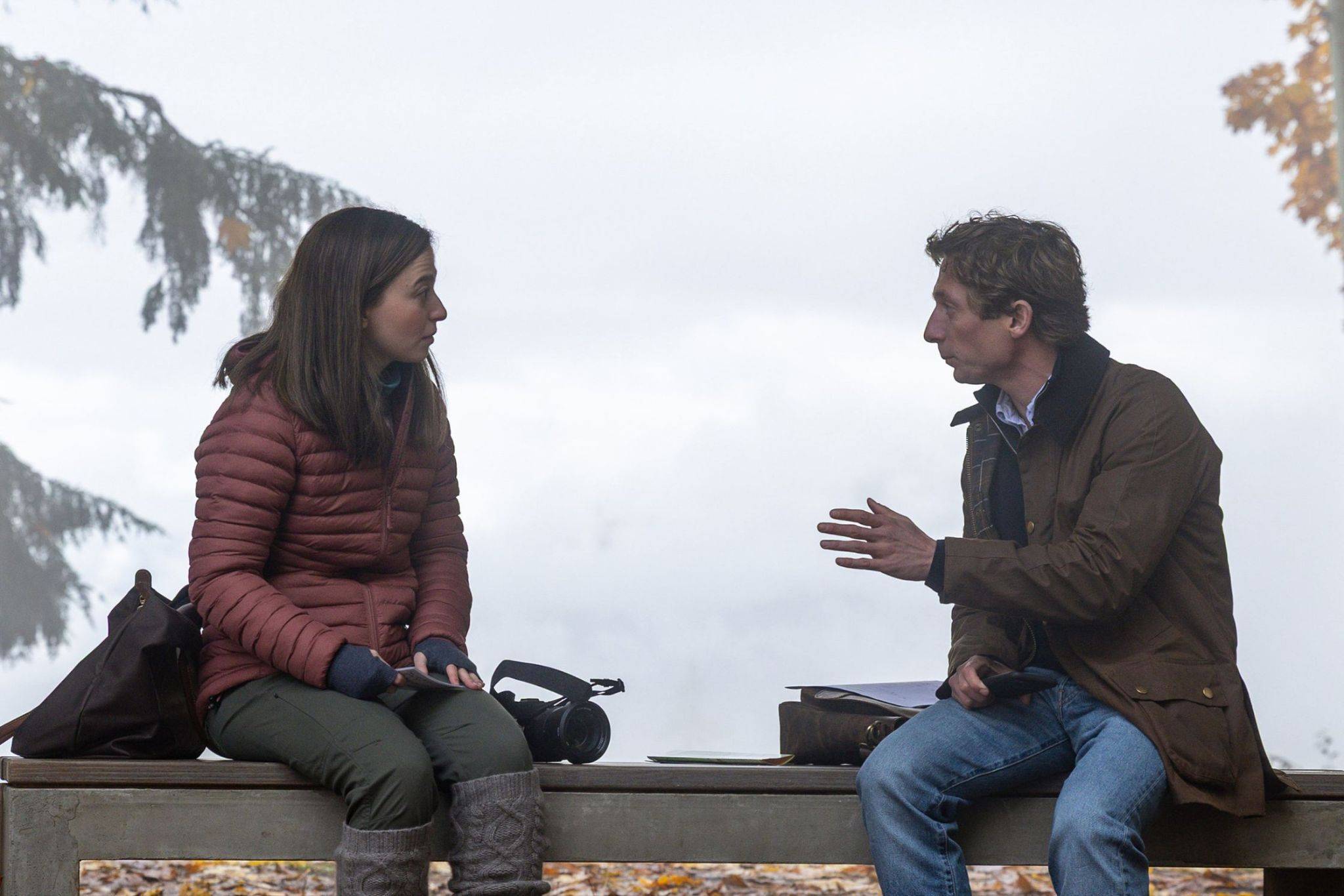Mikey Madison and Jeremy Allen White sit and talk on a bench in “ The Social Reckoning” 2026.