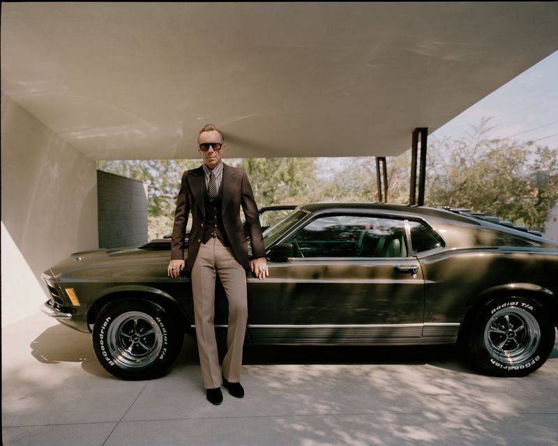 Image may contain: Julian Cope, Blazer, Clothing, Coat, Jacket, Person, Standing, Tire, Formal Wear, Suit, Machine, and Wheel